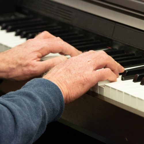 A student playing a piano