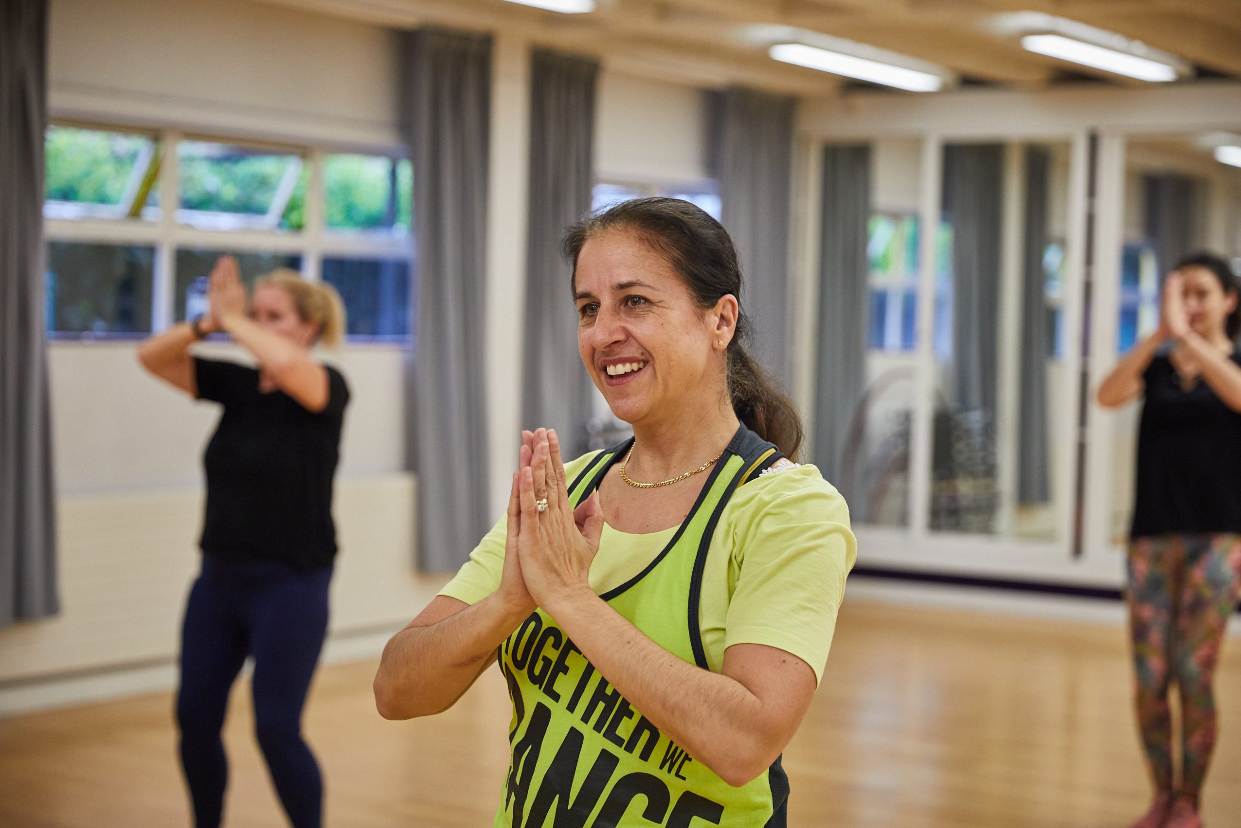 Dance instructor with students in dance hall