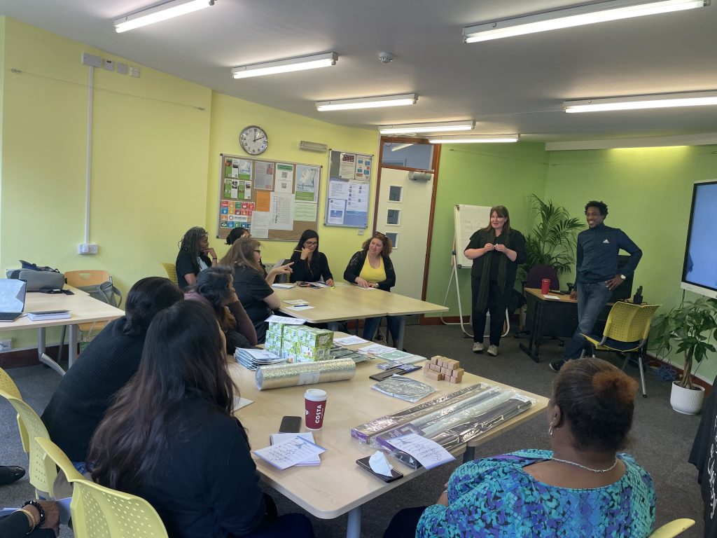 Students sitting around a table in a green living workshop